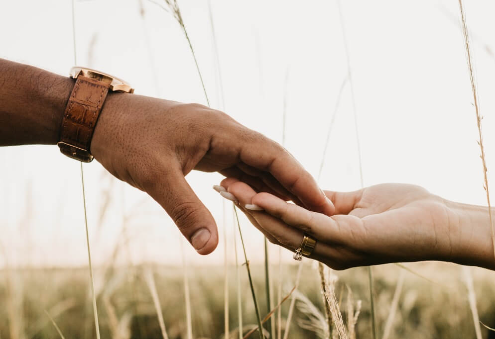 Two hands touching by fingertips.